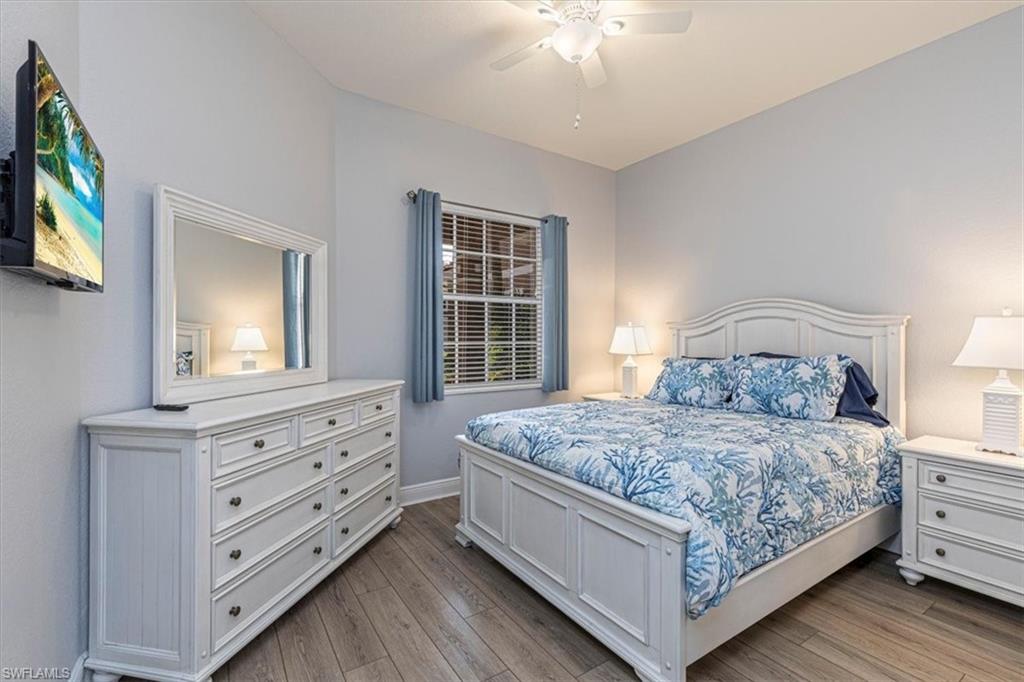 7837 Hawthorne Drive, Unit 1102 Naples, FL 34113 - Photo 18 of 33 Bedroom with light wood-type flooring and ceiling fan