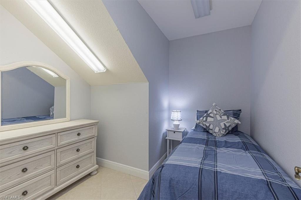 7837 Hawthorne Drive, Unit 1102 Naples, FL 34113 - Photo 21 of 33 Bedroom with baseboards