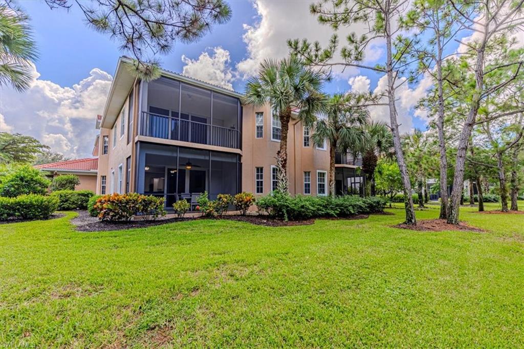 7837 Hawthorne Drive, Unit 1102 Naples, FL 34113 - Photo 24 of 33 Back of property featuring a sunroom, a lawn, a balcony, stucco siding, and a ceiling fan