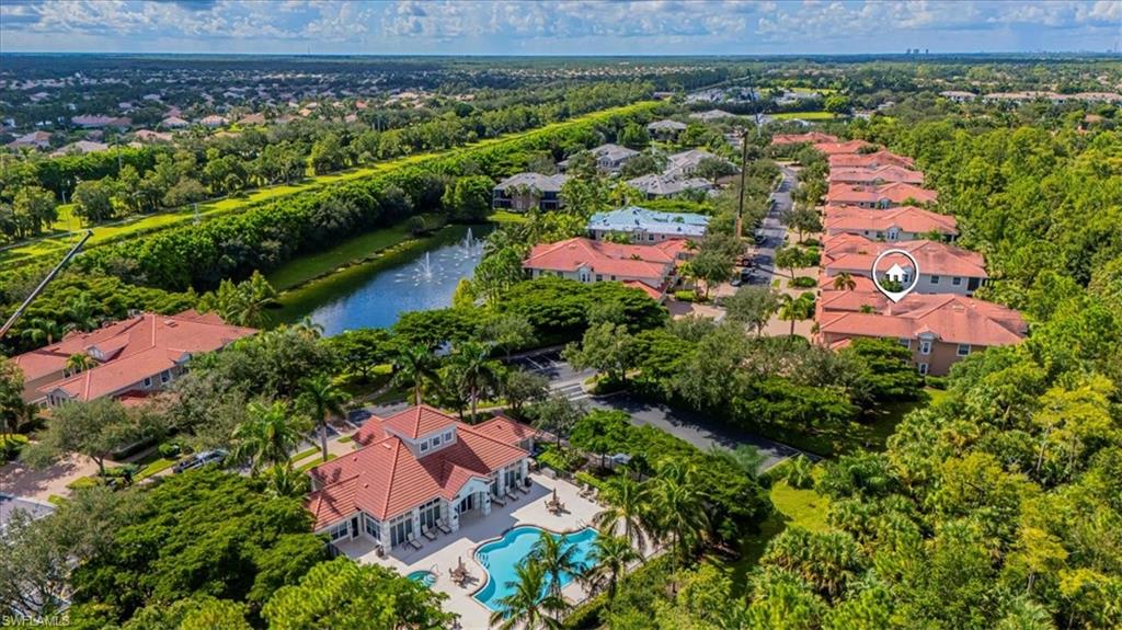 7837 Hawthorne Drive, Unit 1102 Naples, FL 34113 - Photo 29 of 33 Aerial perspective of suburban area featuring a large body of water and a pool area