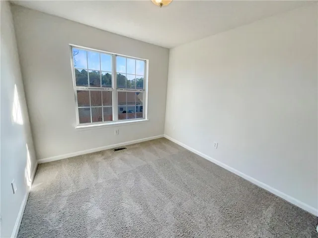 a bedroom with a large bed and flat screen tv