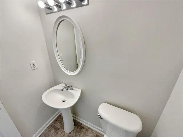 a white toilet sitting next to a bath tub
