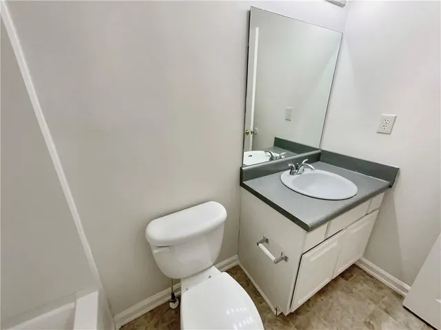 a white toilet sitting next to a bathroom sink