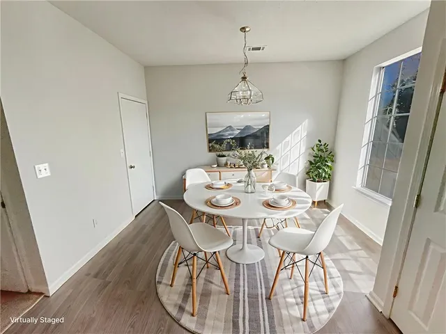 a view of a dining room with furniture window and wooden floor
