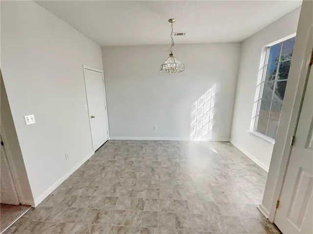 a view of empty room with a fireplace