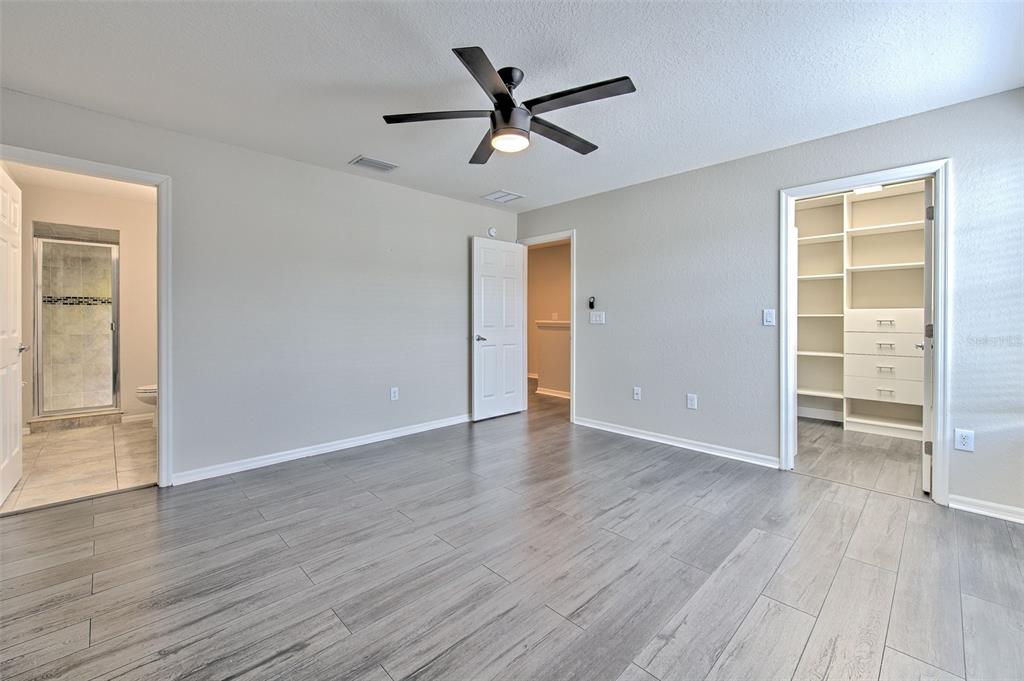 27528 Desert Willow Way Wesley Chapel, FL 33544 - Photo 13 of 24 wooden floor in an empty room with a window