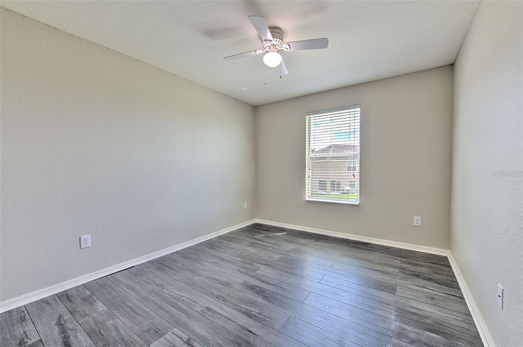 27528 Desert Willow Way Wesley Chapel, FL 33544 - Photo 17 of 24 wooden floor in an empty room with a window