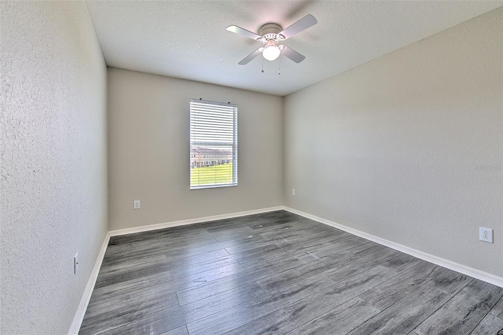 27528 Desert Willow Way Wesley Chapel, FL 33544 - Photo 20 of 24 wooden floor in an empty room with a window