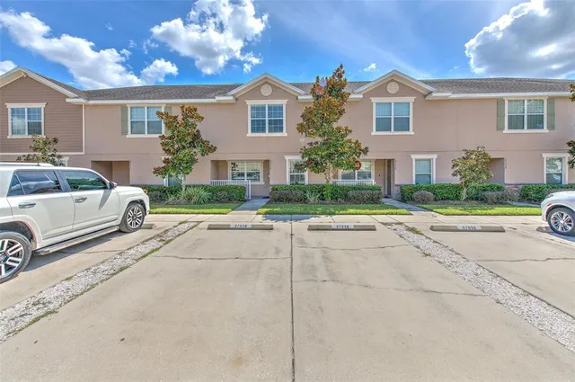 a view of a house with a backyard and a garage