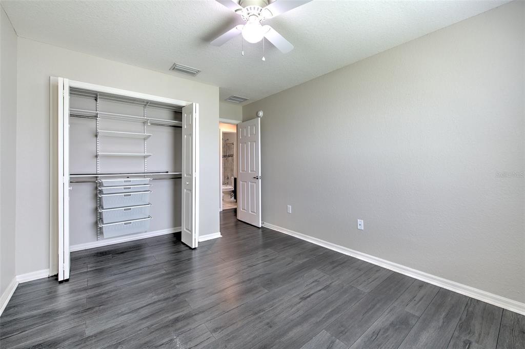 27528 Desert Willow Way Wesley Chapel, FL 33544 - Photo 21 of 24 an empty room with cabinet and wooden floor
