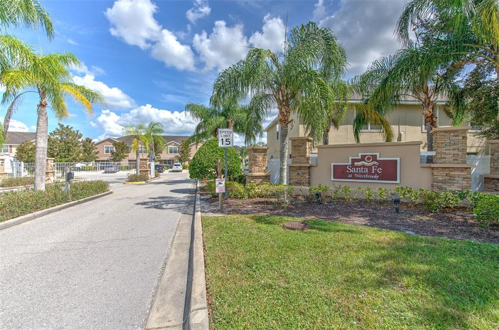 27528 Desert Willow Way Wesley Chapel, FL 33544 - Photo 22 of 24 a view of a street with a building and a street sign