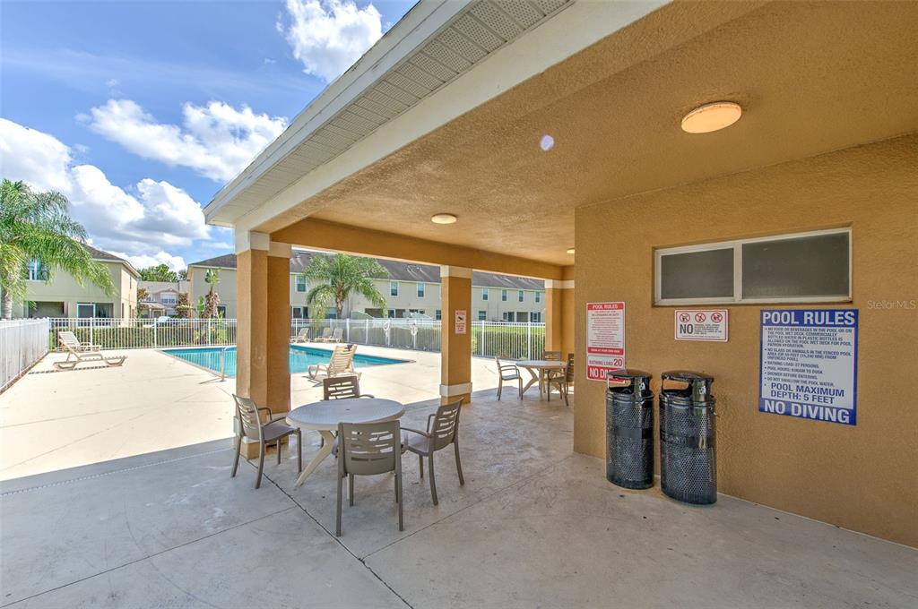 27528 Desert Willow Way Wesley Chapel, FL 33544 - Photo 23 of 24 a dining room with furniture and a floor to ceiling window