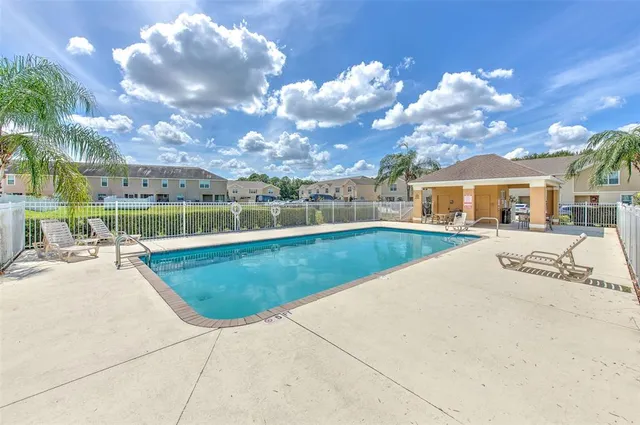a view of a swimming pool with a patio