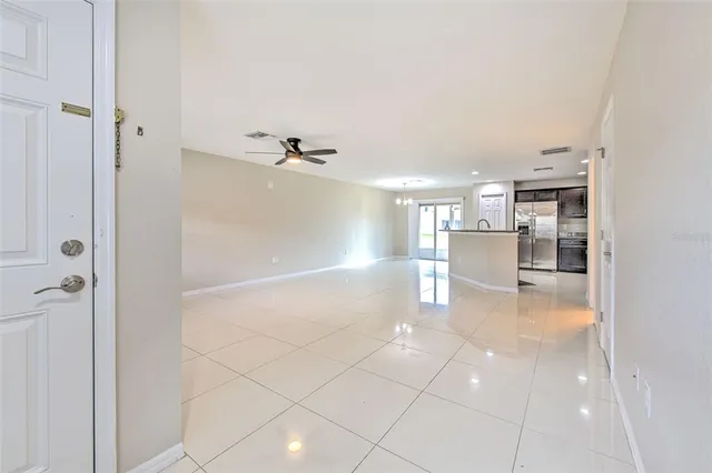a view of a kitchen with a sink and an empty room