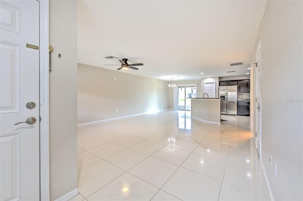 27528 Desert Willow Way Wesley Chapel, FL 33544 - Photo 3 of 24 a view of a kitchen with a sink and an empty room