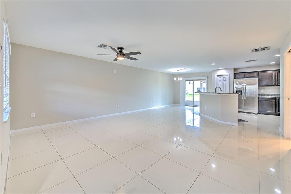 27528 Desert Willow Way Wesley Chapel, FL 33544 - Photo 4 of 24 a view of a kitchen with a sink and a refrigerator