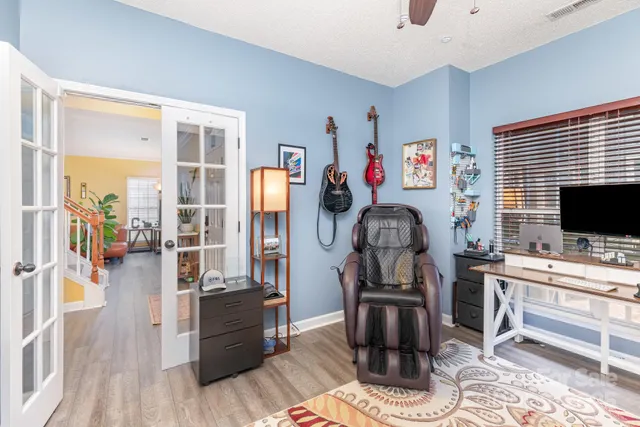 a view of a workspace with furniture and a window