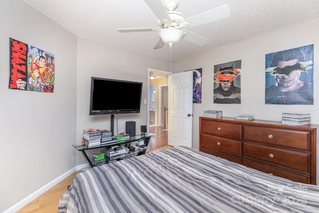 a bedroom with furniture and a flat screen tv