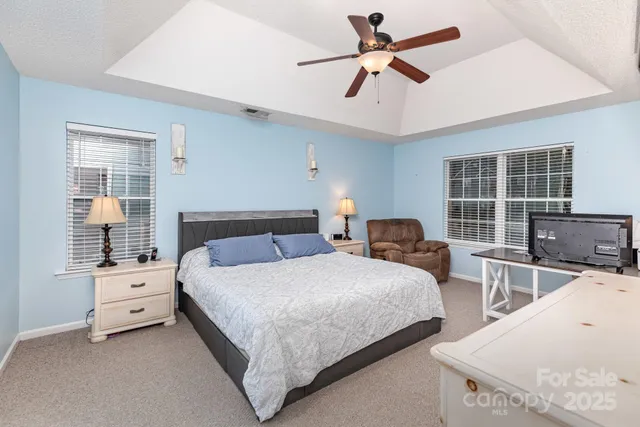 a bedroom with two beds and a flat screen tv