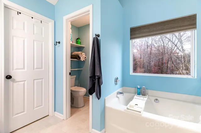a bathroom with a bathtub and a window