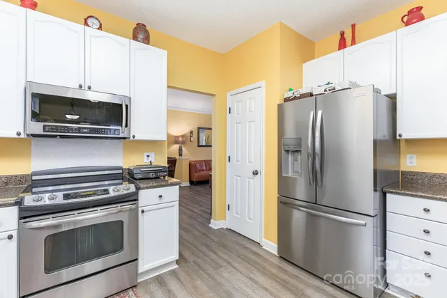 a kitchen with stainless steel appliances a stove microwave and a refrigerator