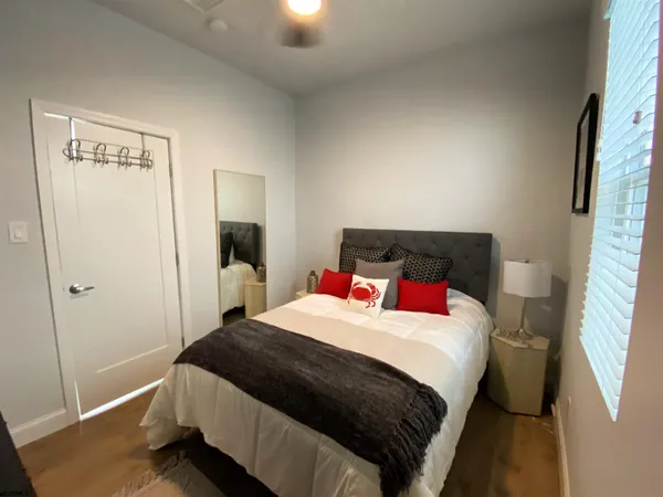a bedroom with a bed and a mirror