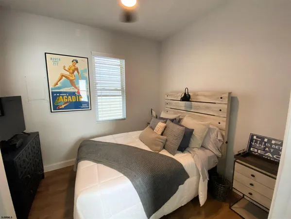 a bedroom with a bed and a television