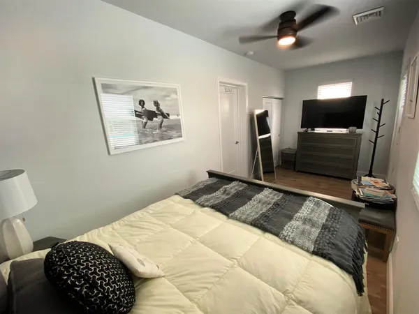 a bedroom with a bed and a flat screen tv
