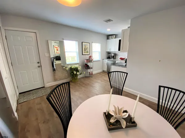 a view of a dining room with furniture window and wooden floor