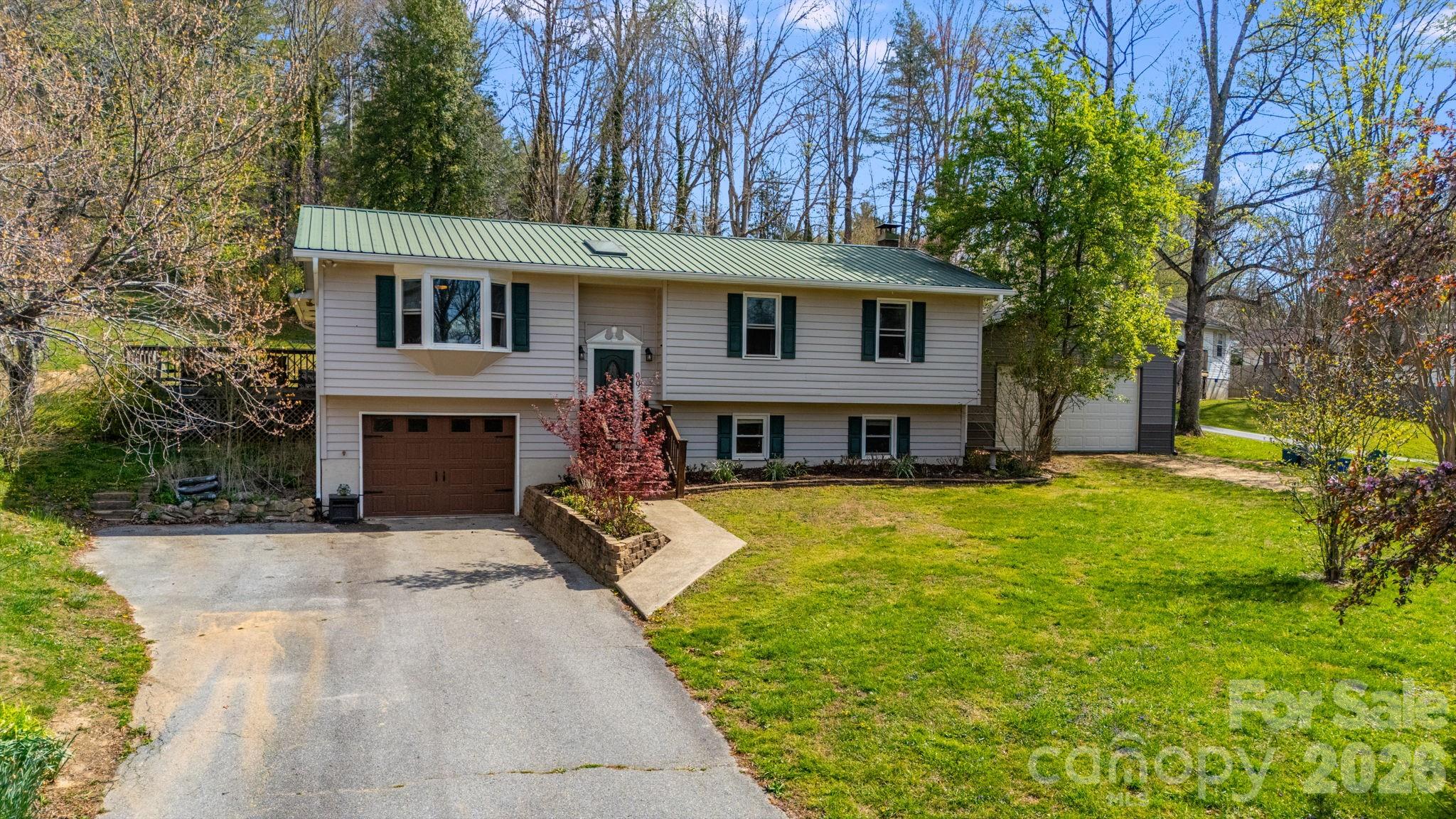 a view of a house with a yard patio and fire pit