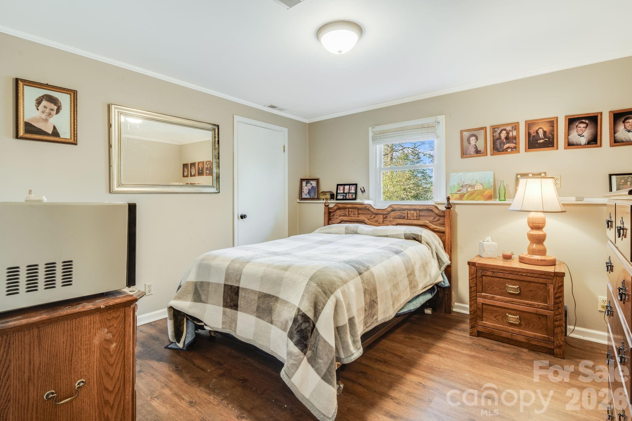 99 South Rowe Road Hendersonville, NC 28792 - Photo 15 of 40 a spacious bedroom with a bed and window