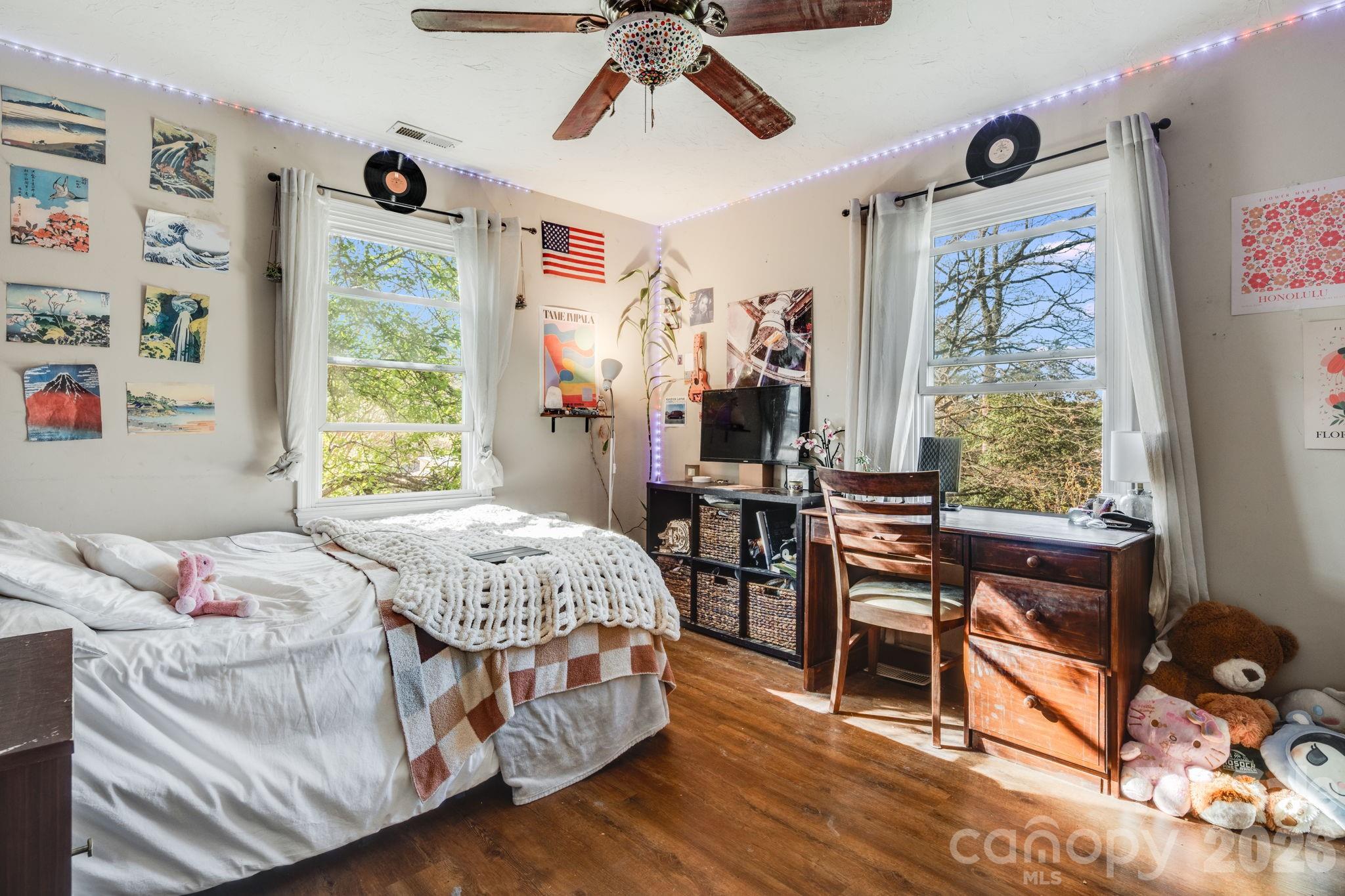 99 South Rowe Road Hendersonville, NC 28792 - Photo 20 of 40 a bedroom with a bed and a table in it next to a window
