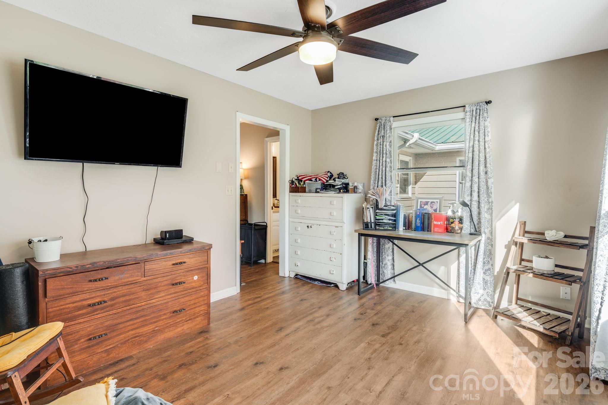 99 South Rowe Road Hendersonville, NC 28792 - Photo 27 of 40 a living room with furniture and a flat screen tv