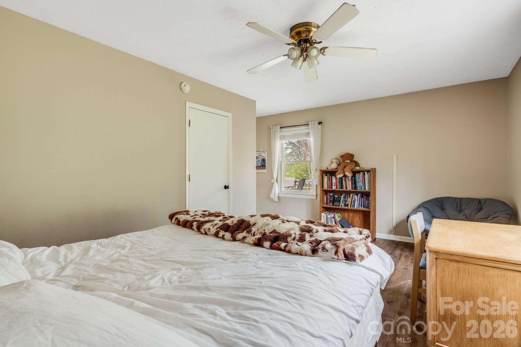 99 South Rowe Road Hendersonville, NC 28792 - Photo 32 of 40 a bedroom with a bed and a chandelier