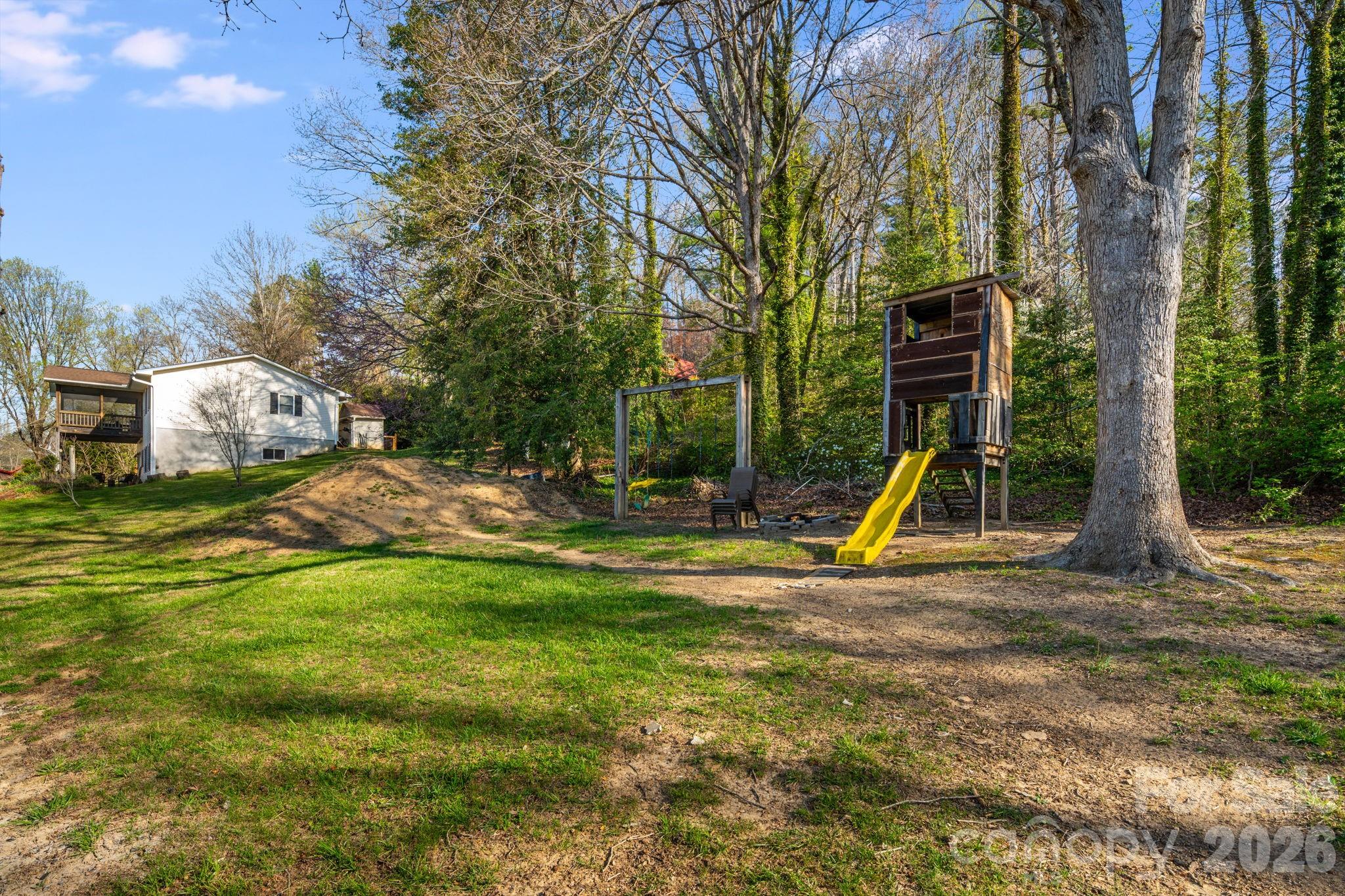 99 South Rowe Road Hendersonville, NC 28792 - Photo 36 of 40 a view of a park with swings and slides