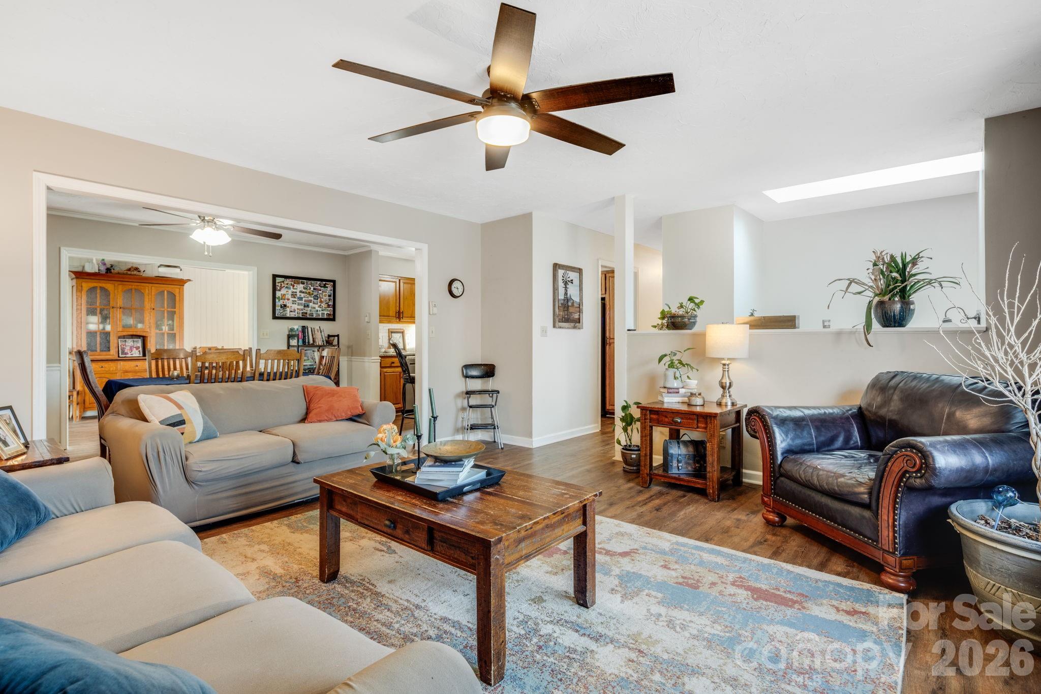 99 South Rowe Road Hendersonville, NC 28792 - Photo 6 of 40 a living room with furniture a ceiling fan and a rug
