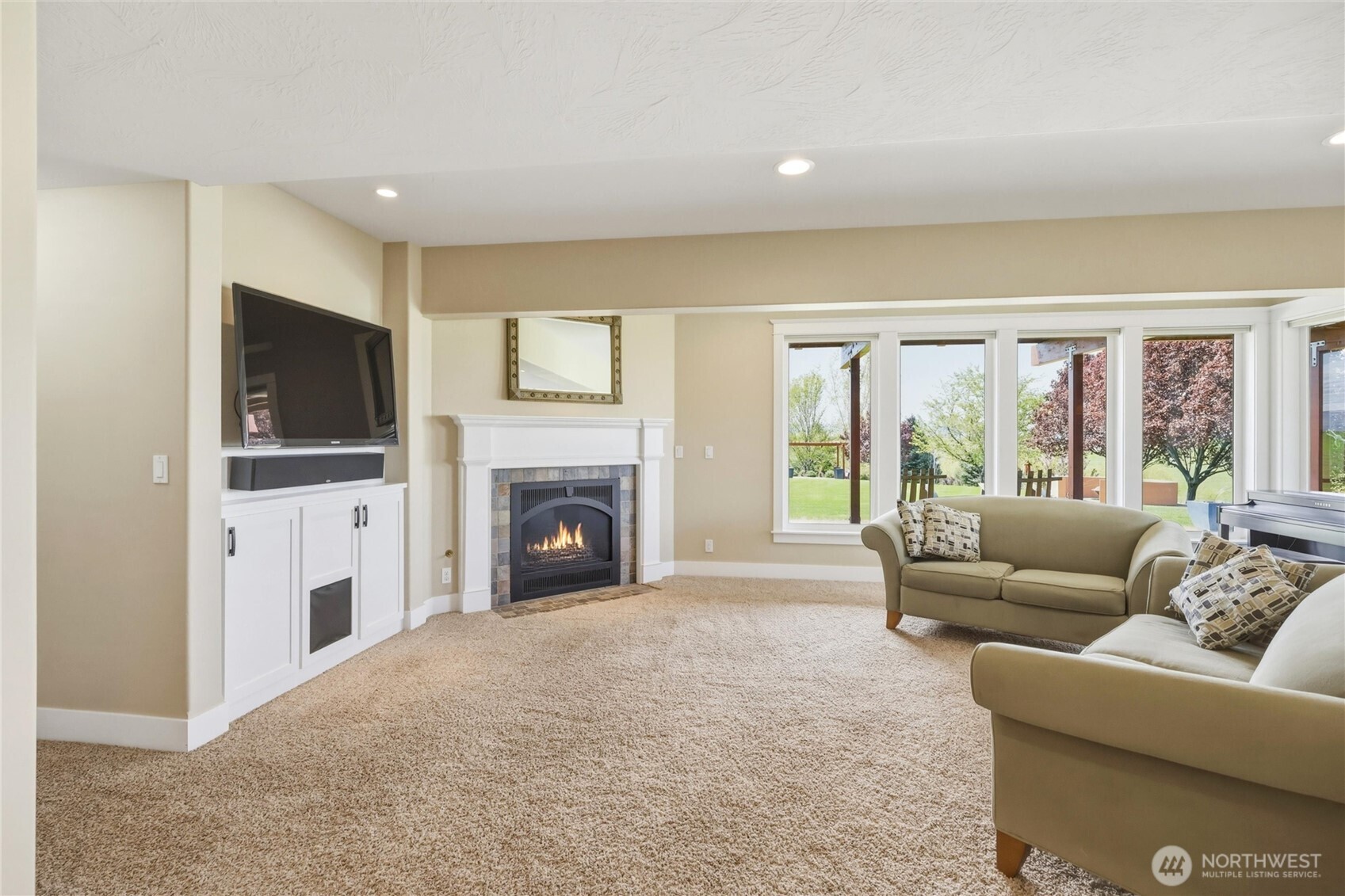 167 Rawhide Road Walla Walla, WA 99362 - Photo 25 of 40 a living room with furniture a flat screen tv and a fireplace
