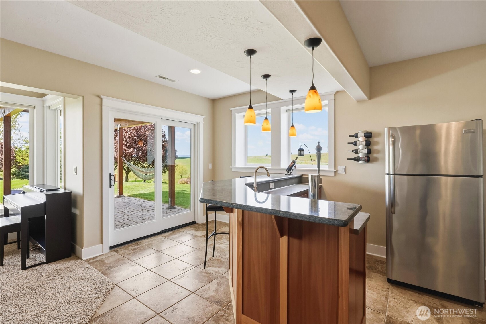 167 Rawhide Road Walla Walla, WA 99362 - Photo 26 of 40 a kitchen with stainless steel appliances granite countertop a refrigerator a sink a dining table and chairs