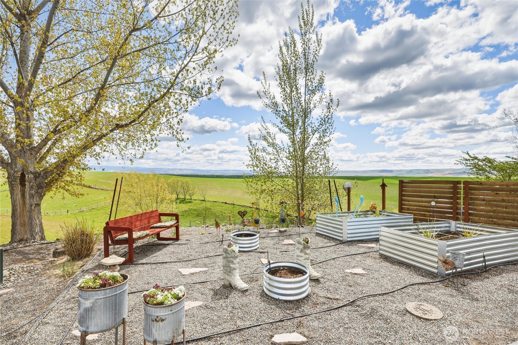 167 Rawhide Road Walla Walla, WA 99362 - Photo 38 of 40 a view of a patio with table and chairs and couches with wooden fence and floor