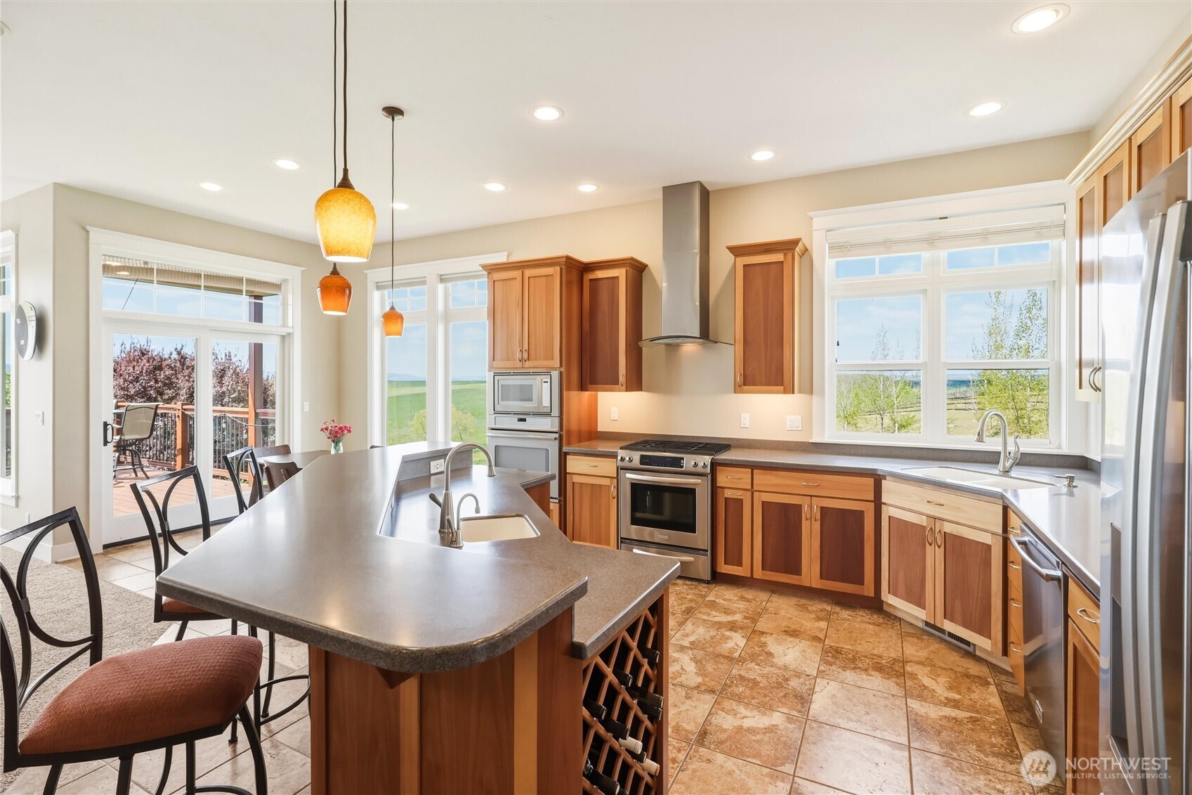 167 Rawhide Road Walla Walla, WA 99362 - Photo 8 of 40 a kitchen with stainless steel appliances granite countertop a stove a kitchen island a dining table and chairs