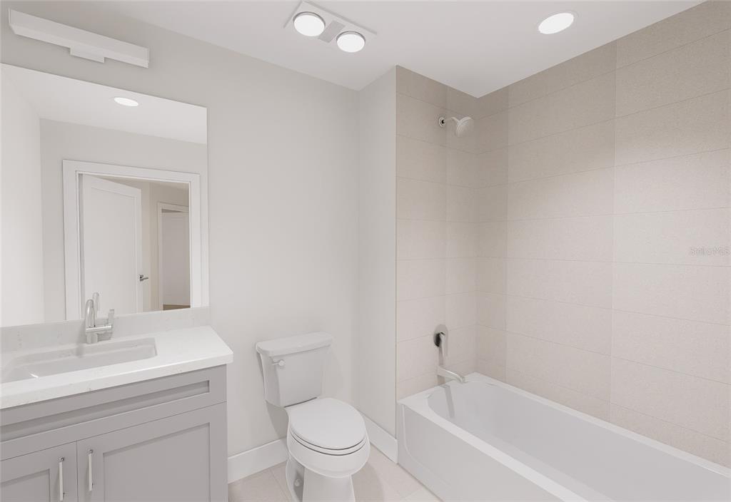 5015 Highway 19, Unit 503 New Port Richey, FL 34652 - Photo 24 of 24 a bathroom with a bathtub shower sink vanity mirror and toilet