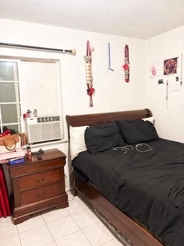 a living room with a bed and a window