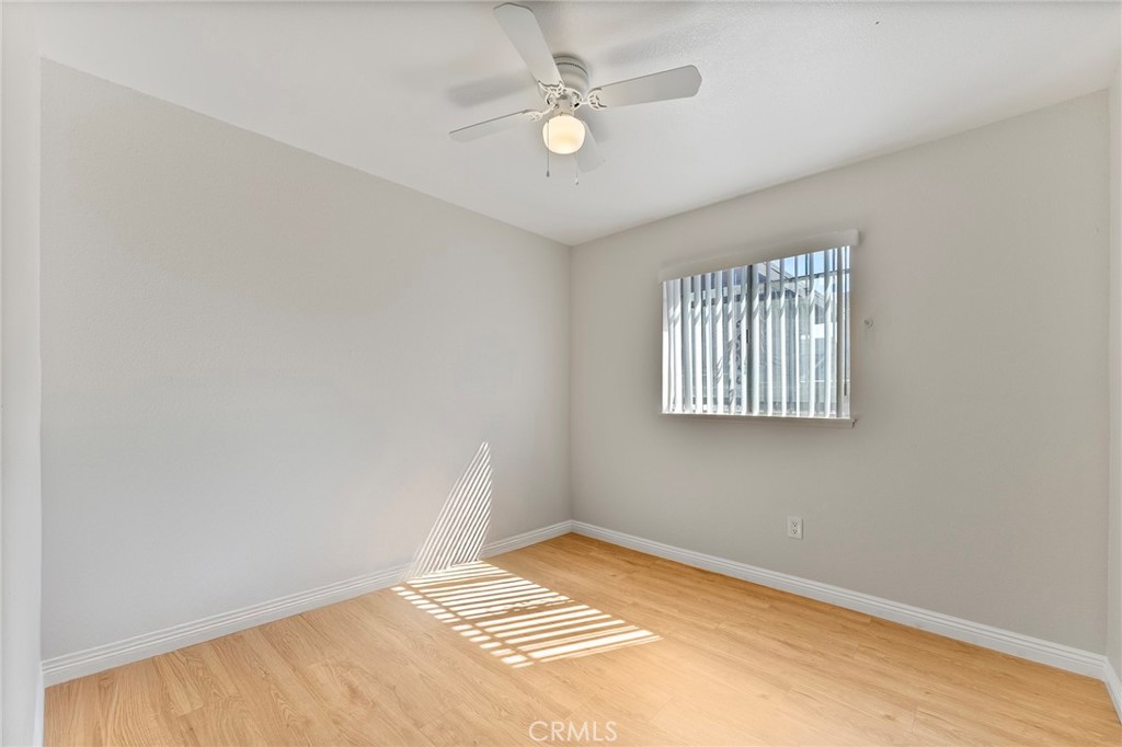 27875 Rainbow Lane Highland, CA 92346 - Photo 11 of 37 an empty room with windows and ceiling fan