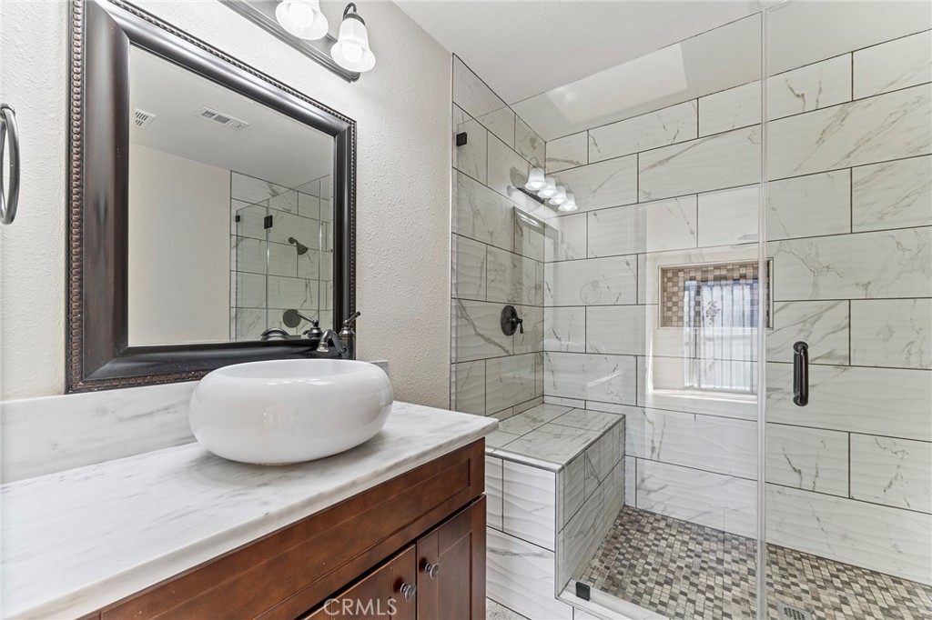 27875 Rainbow Lane Highland, CA 92346 - Photo 17 of 37 a bathroom with a granite countertop sink a toilet and shower