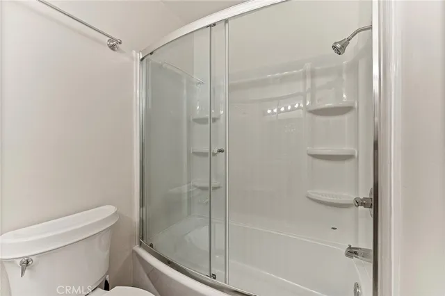 a bathroom with a glass shower door