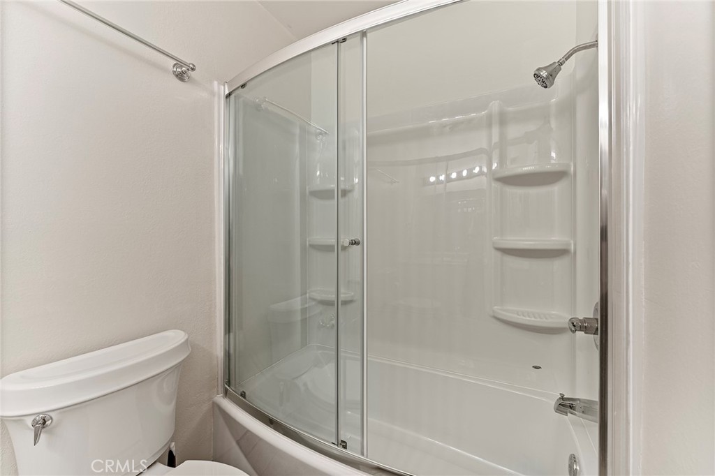 27875 Rainbow Lane Highland, CA 92346 - Photo 20 of 37 a bathroom with a glass shower door