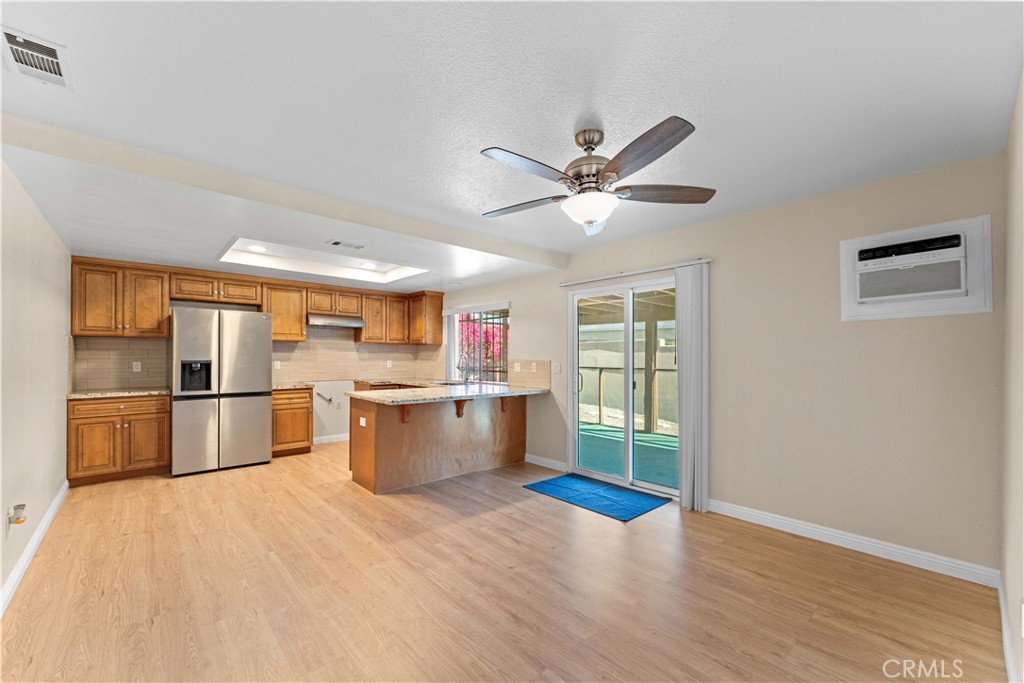27875 Rainbow Lane Highland, CA 92346 - Photo 2 of 37 a kitchen with stainless steel appliances granite countertop a refrigerator a sink dishwasher and a stove with wooden floor