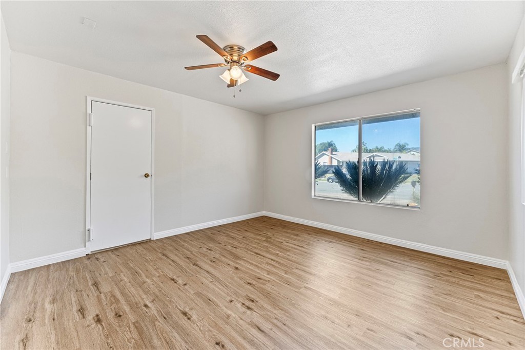 27875 Rainbow Lane Highland, CA 92346 - Photo 21 of 37 an empty room with wooden floor and windows
