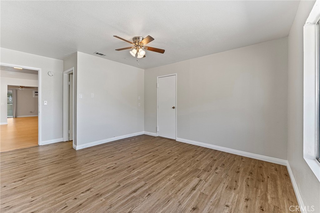 27875 Rainbow Lane Highland, CA 92346 - Photo 22 of 37 a view of an empty room and wooden floor