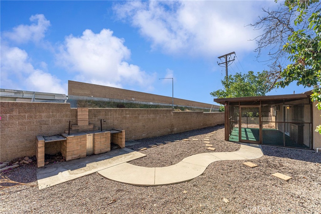 27875 Rainbow Lane Highland, CA 92346 - Photo 25 of 37 a backyard of a house with fountain table and chairs